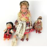 A mid 20th century stuffed Austrian doll with a painted plaster head,