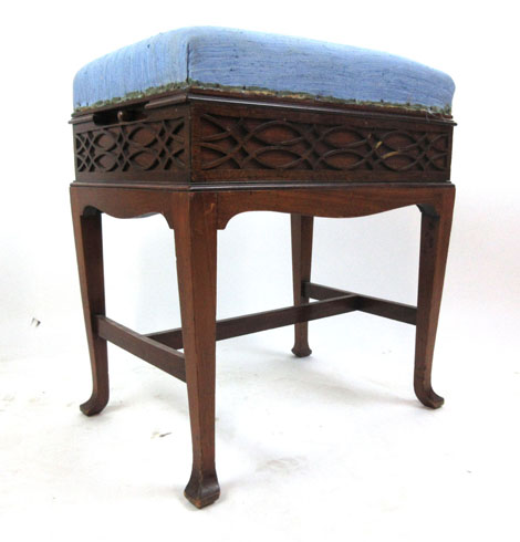 An early 20th century mahogany adjustable piano stool with blue fabric upholstered seat over blind