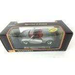 A boxed Maisto Special Edition 1:18 Porsche Boxster with silver livery with red interior