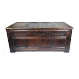 An 18th century and later oak panelled coffer,