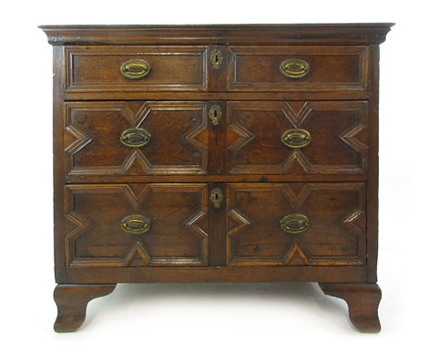 A late 17th century and later oak chest of three long drawers on later feet, h. 82 cm, w.