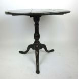 An 18th century oak tripod table, the circular top over turned column and three splay legs, h.