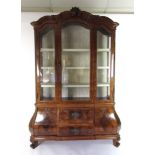 A 19th century Dutch walnut and inlaid display cabinet with beveled glass and a water silk lined