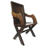 A 19th century and earlier oak Glastonbury chair with fielded panel to back over a paneled seat, h.