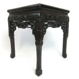 A 19th century Chinese padouk and marble topped stand with carving to the frieze and knees on ball