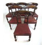 A set of six Victorian mahogany dining chairs with red leatherette upholstery and carved top rail