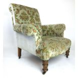 An Edwardian walnut arm chair upholstered in a light green cut fabric on turned front legs, h.