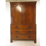 A late 18th century and later oak linen press with two cupboard doors opening to reveal a vacant