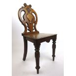 A 19th century oak hall chair, the pierced and carved back over turned front legs, h. 88 cm, w.