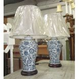 TABLE LAMPS, a pair, blue and white flowers, Chinese bases and cream silk shades, 63cm H.