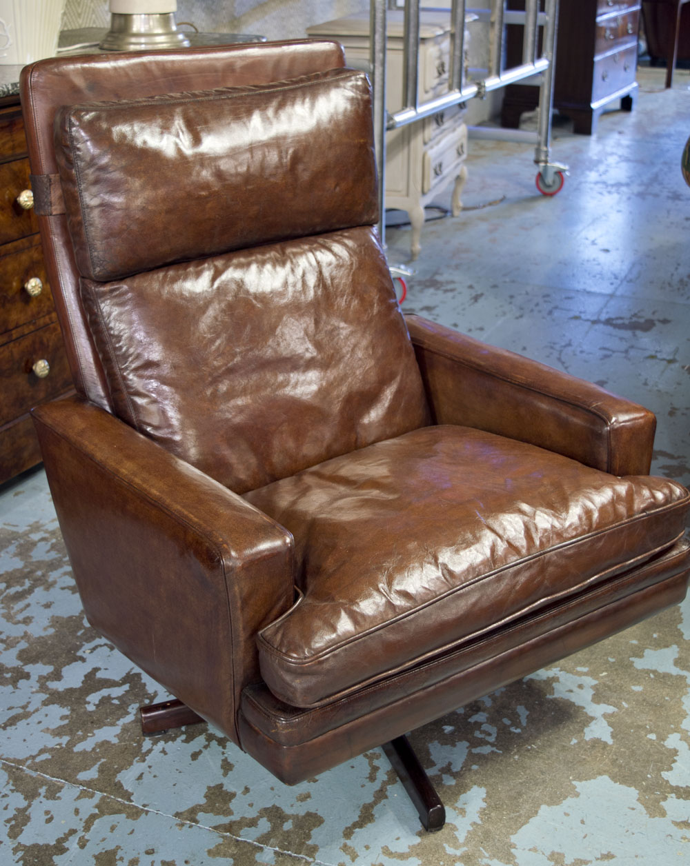 EASY ARMCHAIR, 1970's, mushroom brown leather cushion, revolving on rosewood five star base.