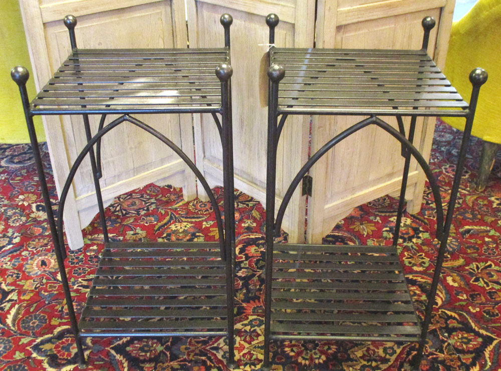 STANDS, a pair, wrought iron, each square with finials and undertier, 36cm x 36cm x 72cm H.