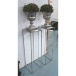 JARDINIERE STANDS, a pair, with mounted pots containing faux laurel bushes,