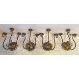 WALL LIGHTS, a set of four, early 20th century gilt iron with three scrolling branches,