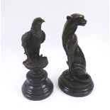 BRONZE SCULPTURES, two, seated puma and a bird of prey, both with marble bases,