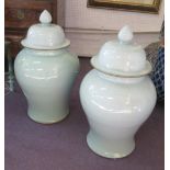 TEMPLE JARS WITH COVERS, a pair, celadon coloured, 68cm H.