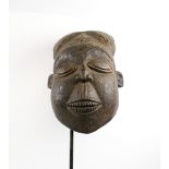 LARGE BAMOUN HEAD MASK, carved wood, 40cm x 26cm, presented on modern display stand.