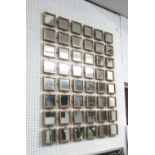 MIRROR WALL ART, with forty eight square mirrors in a gilded frame, 101cm x 75cm.