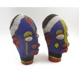 IFE HEADS, a pair, clad in colourful beaded detail, each 31cm H.