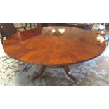 CIRCULAR EXTENDING DINING TABLE, Regency style figured mahogany, the top with radial veneers,