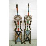 LARGE TIKAR DOLLS, a pair, carved wood with colourful beaded decoration, each 152cm H.