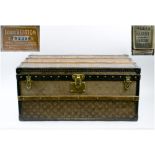 LOUIS VUITTON TRUNK, early 20th century monogram canvas with rising lid with leather side handles,