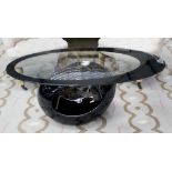 LOW TABLE, mid century design, oval glass top with black open border, on a black globular base,