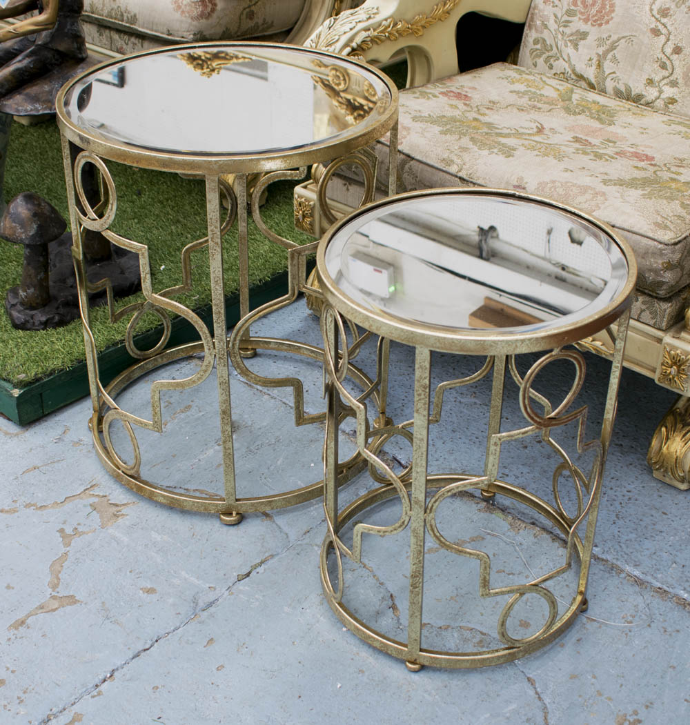 MIRRORED OCCASIONAL TABLES, a graduated pair, on a metal base, largest 46cm diam. x 55cm H.