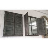 GARDEN MIRRORS, a pair, in louvre shutter style frame a rustic metal, 70cm x 58cm.