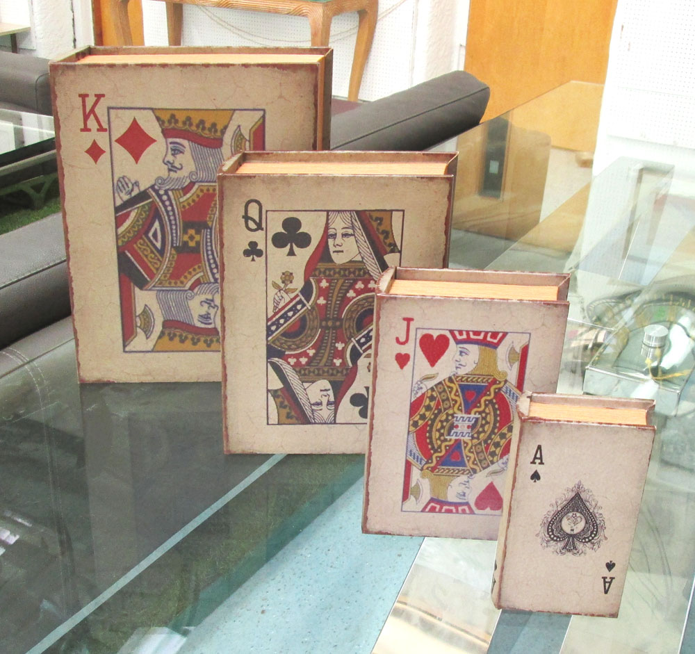 STORAGE BOOKS, a set of four, playing card designs in antiqued bindings, lined interiors,