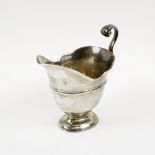SCOTTISH SILVER CREAM JUG, early 18th century, of helmet form with scroll handle,
