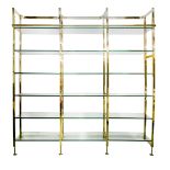 OPEN SHELVES, by Eichholtz, brass frame containing adjustable glass shelving,