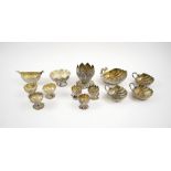 SMALL INDIAN SILVER METAL ITEMS, thirteen various, including shell shaped cups, lotus leaf vase etc.