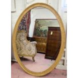 WALL MIRROR, Georgian style oval gilt and composition with guilloche frame, 140cm H x 105cm W.