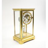 MANTEL CLOCK, late 19th century brass with four glass panels, dial with visible escapement,