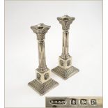 SILVER CANDLESTICKS, a pair, of Classical column form, Birmingham 1939, makers Britton, Gould & Co.