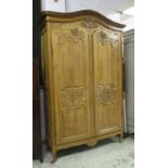 ARMOIRE, early 19th century, French, carved pine, with two panelled doors enclosing shelves,