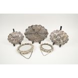 PERSIAN SILVER HAND MIRRORS, five of varying sizes, all with reposse decorated backs, largest,