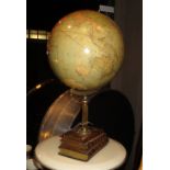 GLOBE, hand made, on a brass fluted stand and three books, 56cm H.