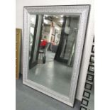 MIRROR, bevelled in an ornate silver painted frame, 146cm x 115cm.