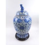 CHINESE LIDDED VASE, late 20th century blue/white ceramic, 60cm H with wooden stand.