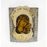 ICON, painted study of Mother of God and baby Christ with embossed silver coloured metal oklad,