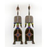 TIKAR DOLLS, a pair, carved wood with colourful beaded decoration, each 102cm H.