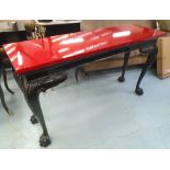 CONSOLE TABLE, red top, black base with cabriole moulded supports ahd hairy paw feet,