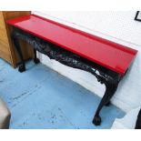 CONSOLE TABLE, red top, black base with cabriole moulded supports and hairy paw feet,