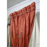 CURTAINS, a pair, in salmon coloured fabric, lined and interlined, 84cm W gathered x 255cm drop,