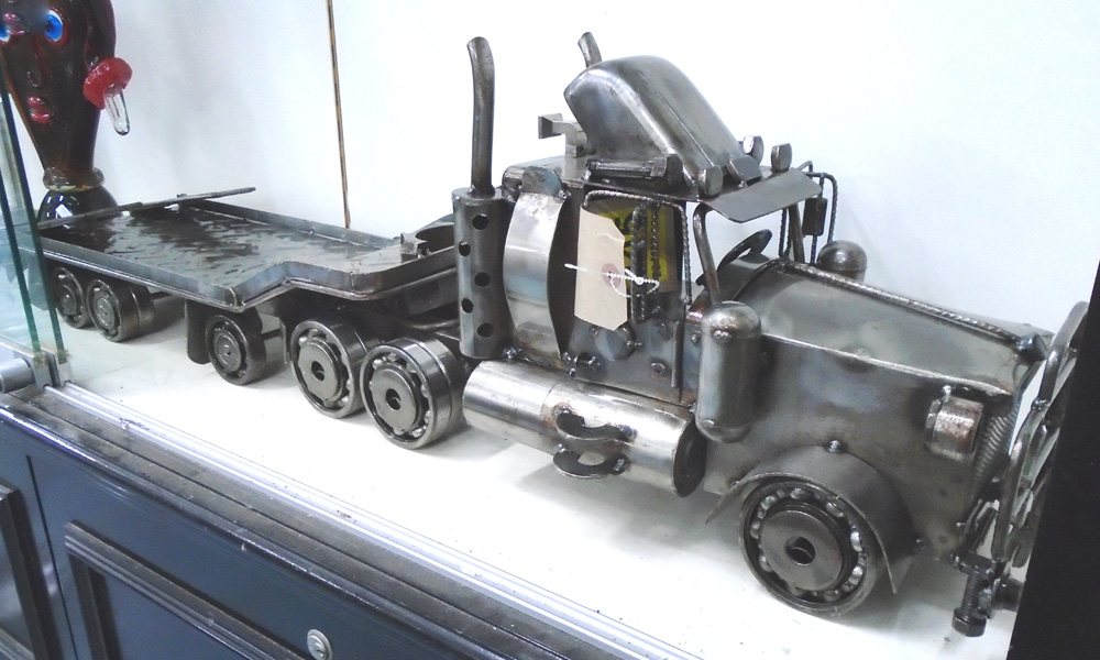 MODEL FLATBED LORRY, articulated lorry made of upcycled steel machine parts, 110cm x 20cm x 30cm.