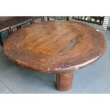 LOW TABLE, circular wooden hand tooled top on curved supports, 136cm diam 40cm H.