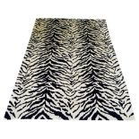 FINE TIBETAN WOOL TIGER DESIGN CARPET, 247cm x 171cm, in noir and ivory.