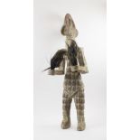 SENUFO FIRE SPITTER FIGURE, carved wood with cowrie shell detail,